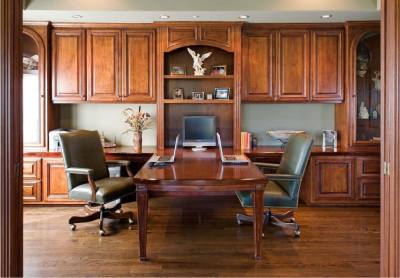 Office with desk and chairs on opposite sides